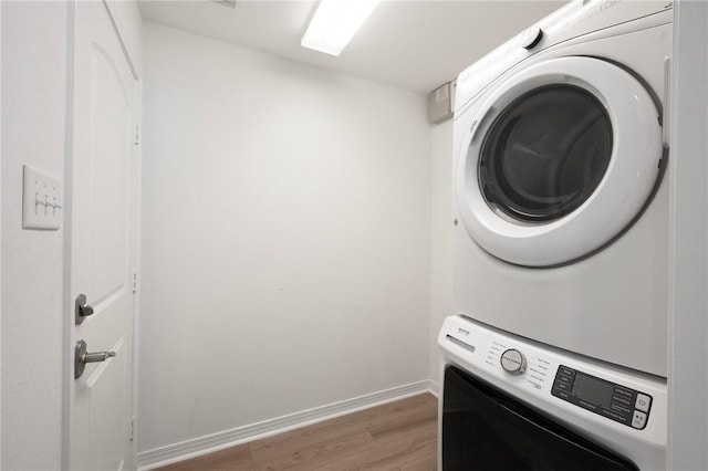 4118 Cedar Creek Ct, College Station, TX 77845 - laundry room with stacked washer / drying machine, light wood-type flooring, and baseboards