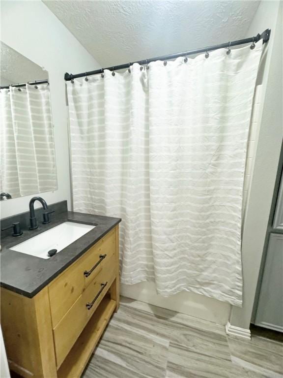 9462 Riley Green Rd, Franklin, TX 77856 - bathroom featuring a textured ceiling and vanity