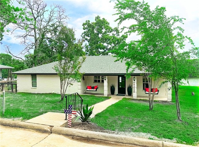 9462 Riley Green Rd, Franklin, TX 77856 - single story home featuring a front lawn, roof with shingles, and a porch
