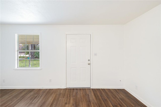 spare room with dark wood-type flooring