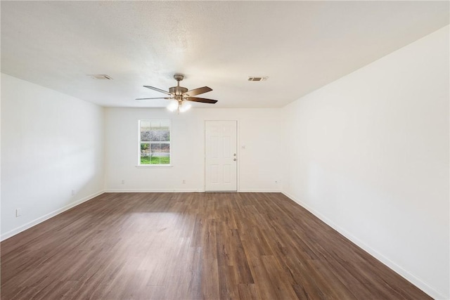 spare room with dark hardwood / wood-style floors, a textured ceiling, and ceiling fan