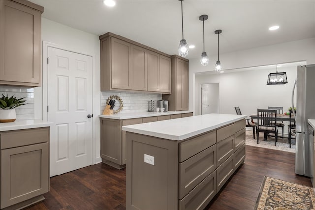 kitchen with decorative backsplash, dark hardwood / wood-style floors, and hanging light fixtures