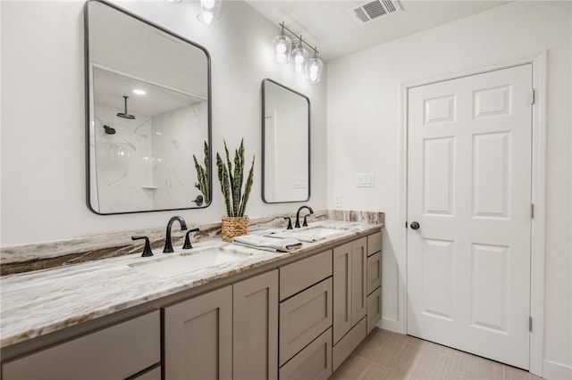 bathroom featuring vanity, tile patterned flooring, and walk in shower