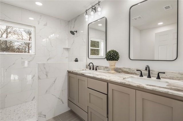 bathroom with vanity and tiled shower