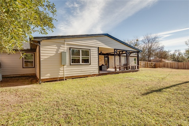 back of house with a lawn