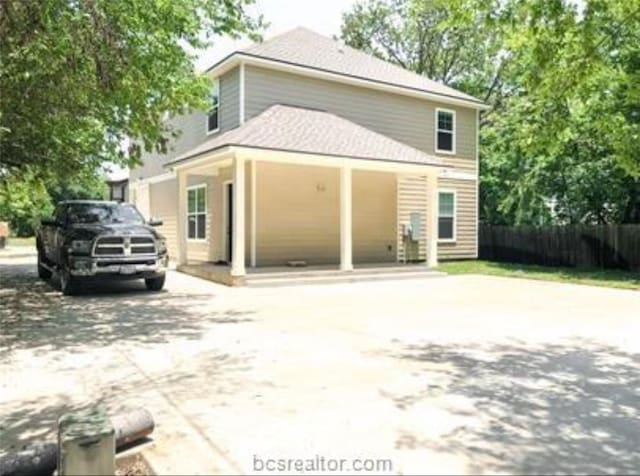 exterior space with fence and concrete driveway