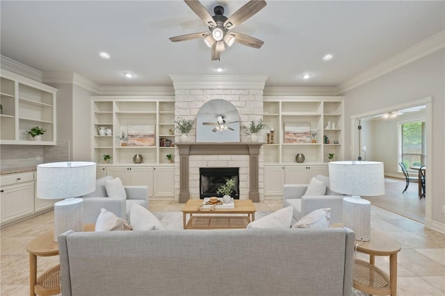 living room featuring crown molding, built in features, a fireplace, a ceiling fan, and light tile patterned floors