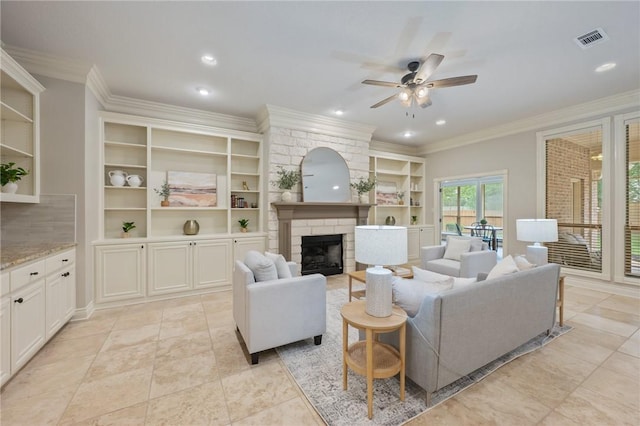 living room with ceiling fan, built in shelves, a stone fireplace, visible vents, and ornamental molding