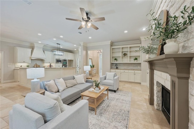 living room with crown molding, ceiling fan, recessed lighting, and light tile patterned flooring