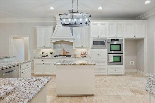 kitchen featuring backsplash, decorative light fixtures, crown molding, white cabinets, and stainless steel appliances