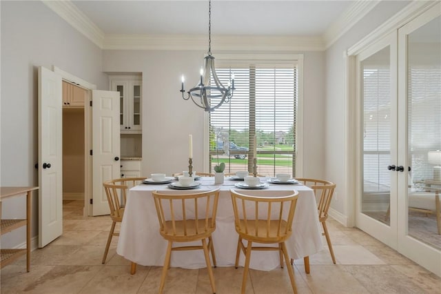 dining room with light tile patterned floors, a notable chandelier, ornamental molding, and french doors
