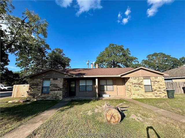 ranch-style home with a front lawn