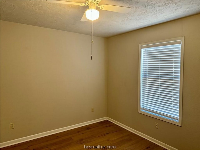 unfurnished room featuring ceiling fan, dark wood-type flooring, and a textured ceiling