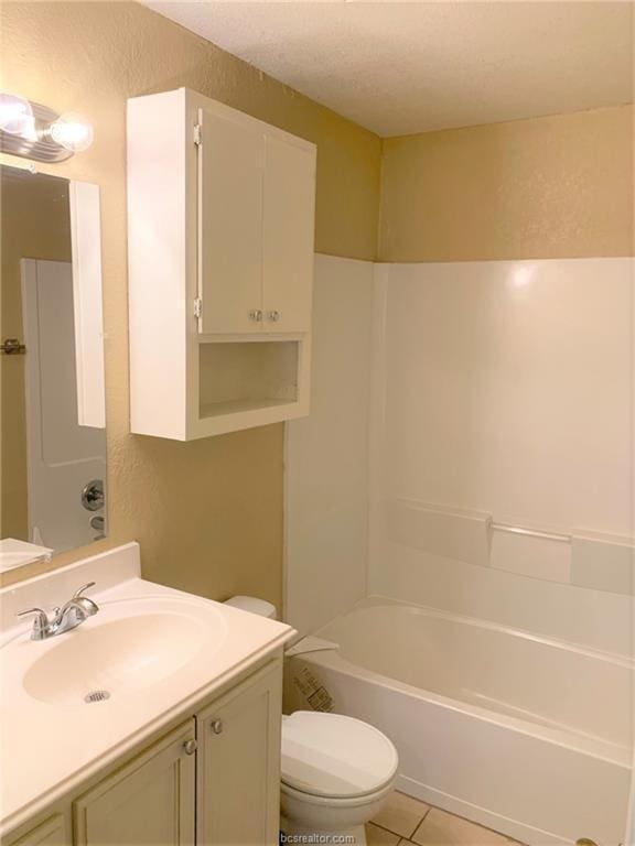 full bathroom with vanity, tile patterned floors, toilet, a textured ceiling, and tub / shower combination