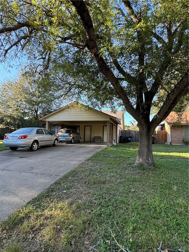 view of front facade with a front yard and a carport