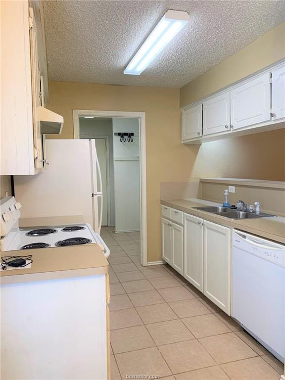 kitchen featuring sink, white cabinets, white appliances, and light tile patterned floors