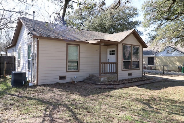 view of front of house with a front lawn and central air condition unit