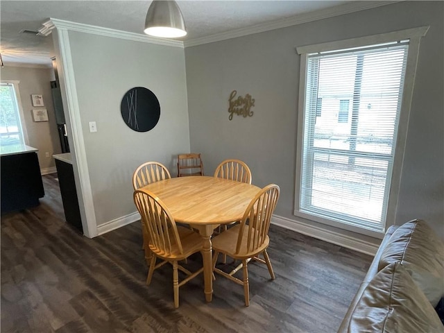 dining space with crown molding and dark hardwood / wood-style flooring