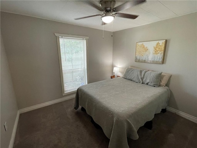 bedroom with ceiling fan and dark carpet