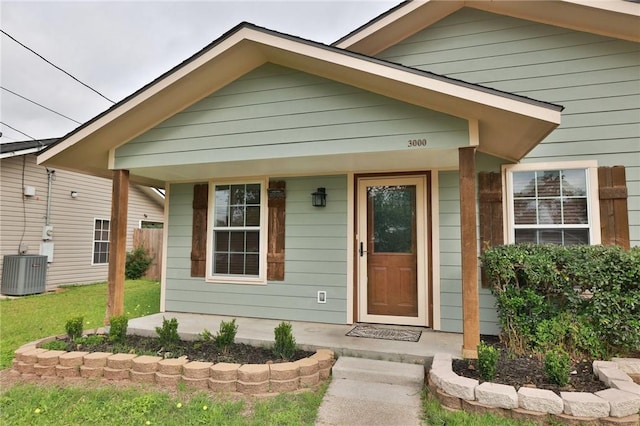 3000 Stevens Dr, Bryan, TX 77803 - property entrance featuring central AC, covered porch, and a lawn