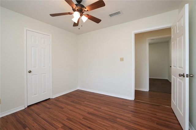 3000 Stevens Dr, Bryan, TX 77803 - spare room with dark wood finished floors, a ceiling fan, and baseboards