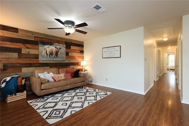 3000 Stevens Dr, Bryan, TX 77803 - living area featuring attic access, wooden walls, ceiling fan, baseboards, and wood finished floors