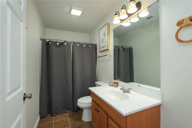 3000 Stevens Dr, Bryan, TX 77803 - bathroom with toilet, vanity, and tile patterned floors