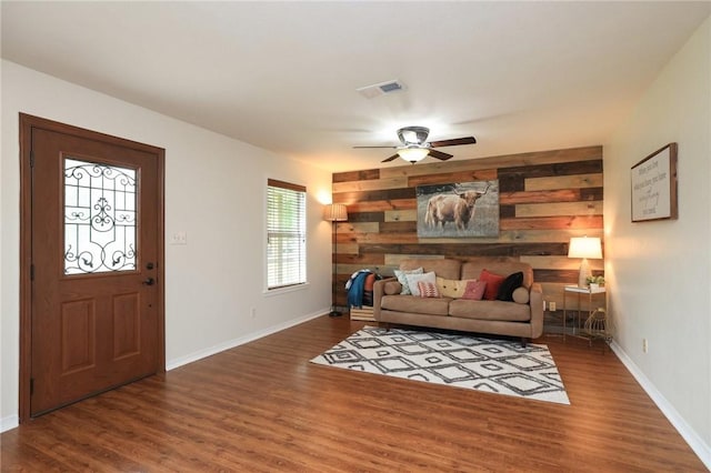 3000 Stevens Dr, Bryan, TX 77803 - living room with a ceiling fan, wood finished floors, baseboards, and wood walls