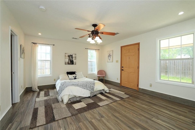 3000 Stevens Dr, Bryan, TX 77803 - bedroom with multiple windows, dark wood finished floors, baseboards, and recessed lighting