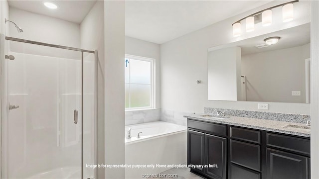 bathroom featuring vanity and separate shower and tub