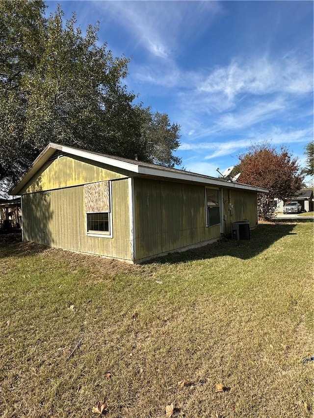 view of home's exterior featuring central air condition unit and a yard