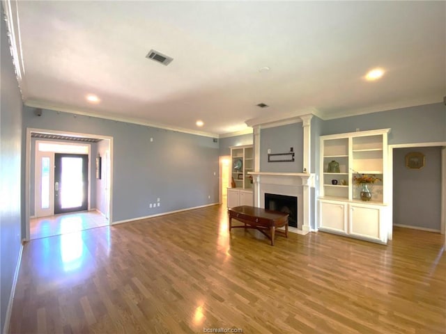 1608 Panther Ln, College Station, TX 77840 - unfurnished living room featuring ornamental molding, baseboards, wood finished floors, a fireplace with flush hearth, and recessed lighting