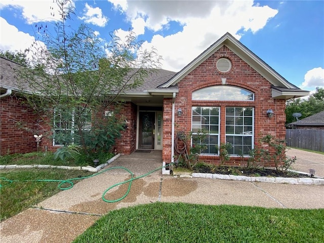 1608 Panther Ln, College Station, TX 77840 - single story home featuring brick siding, a shingled roof, and fence