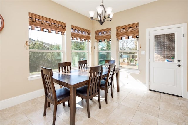 tiled dining area with a healthy amount of sunlight and a notable chandelier