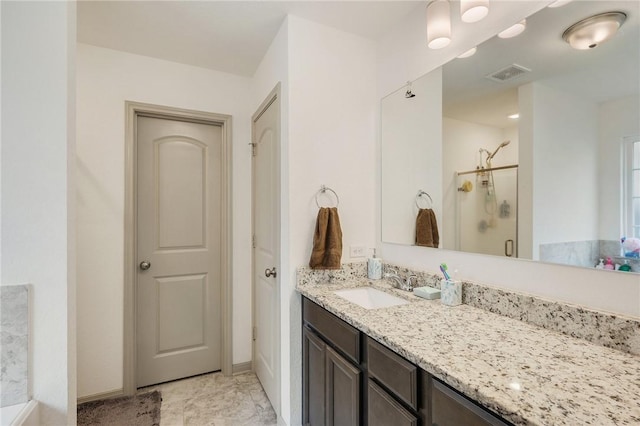 bathroom featuring vanity and an enclosed shower