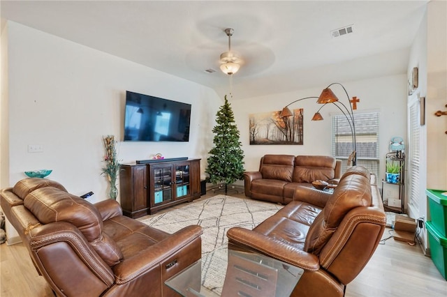 living room featuring ceiling fan and light hardwood / wood-style floors