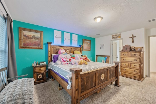 carpeted bedroom with a textured ceiling