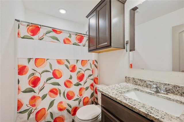 bathroom with vanity, toilet, and a shower with shower curtain