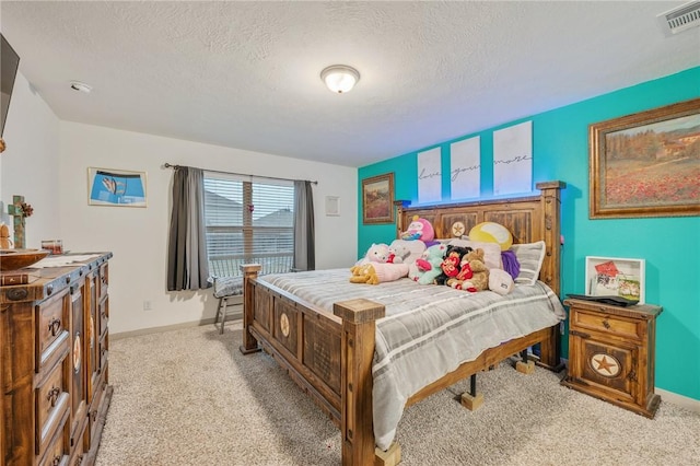 bedroom with light carpet and a textured ceiling