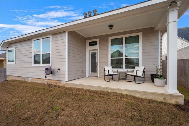 back of property featuring a patio and a lawn