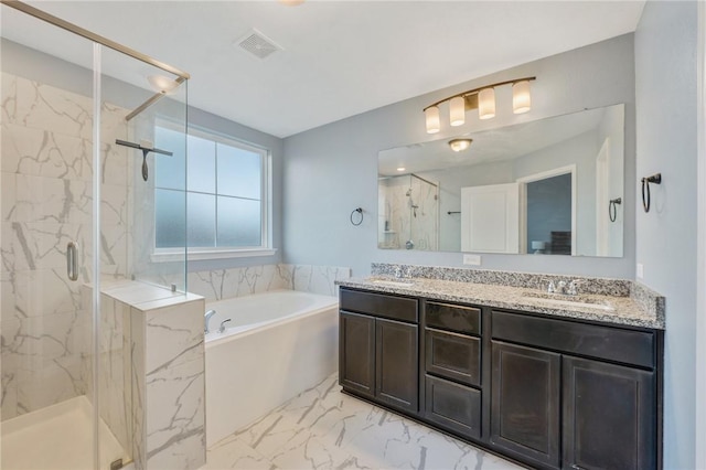 bathroom with vanity and shower with separate bathtub