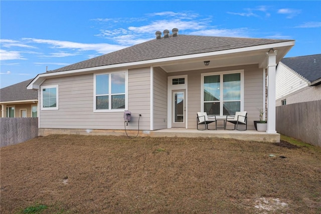 back of house with a lawn and a patio area