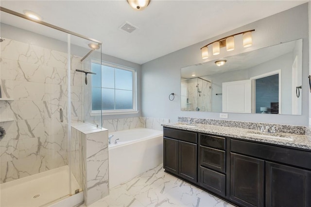 bathroom with vanity and independent shower and bath