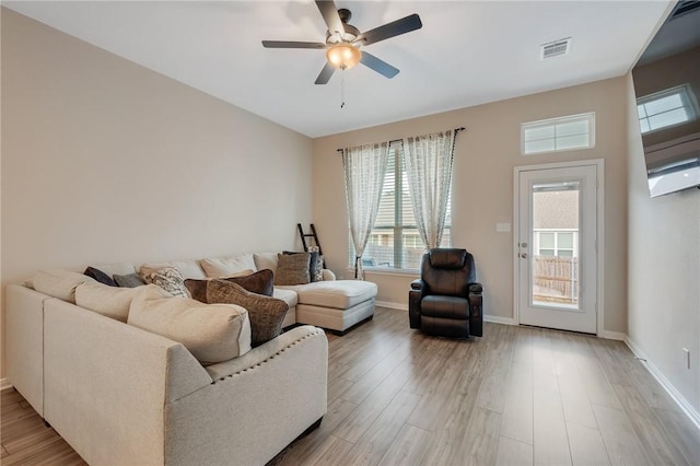 living room featuring wood-type flooring and ceiling fan