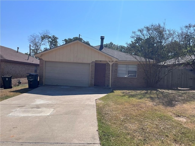 ranch-style house featuring a garage and a front lawn