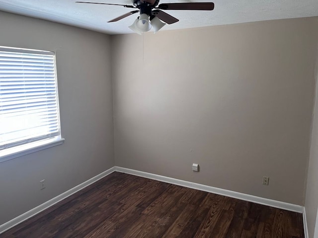 spare room with dark hardwood / wood-style flooring, plenty of natural light, and ceiling fan