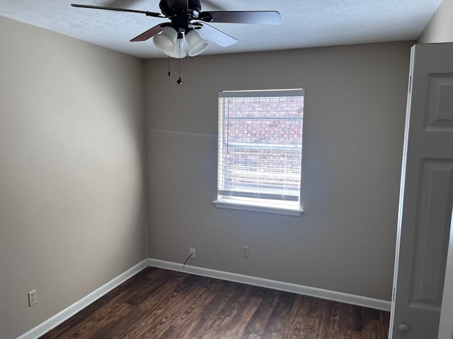 empty room featuring a textured ceiling, ceiling fan, and dark wood-type flooring