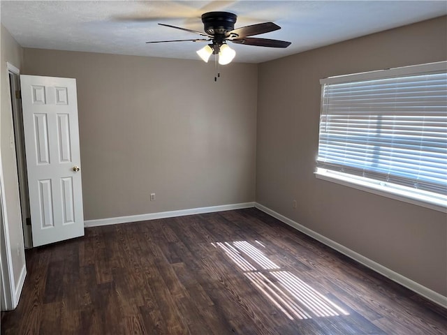 unfurnished room featuring dark hardwood / wood-style flooring and ceiling fan