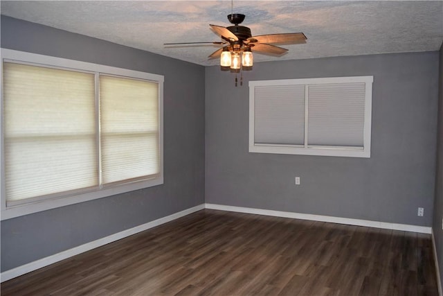 unfurnished room with a textured ceiling, ceiling fan, and dark hardwood / wood-style flooring