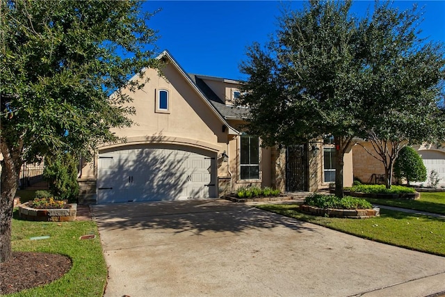 view of front of property featuring a front lawn and a garage